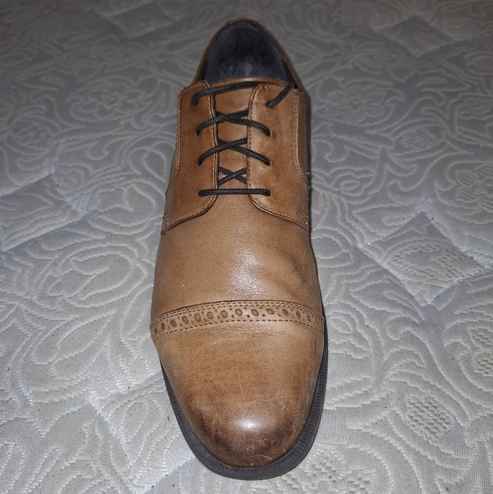 A pair of Cole Haan Oxfords in a men's size 12M. Pre-loved in good condition.
